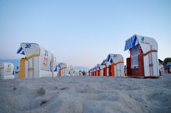 Scharbeutz Reihen von bunten Strandkörben auf einem Sandstrand bei Dämmerung.